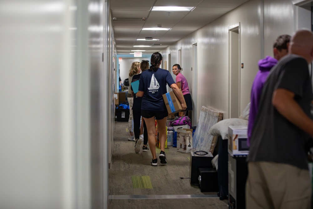 Group of people in the hallway with their stuff